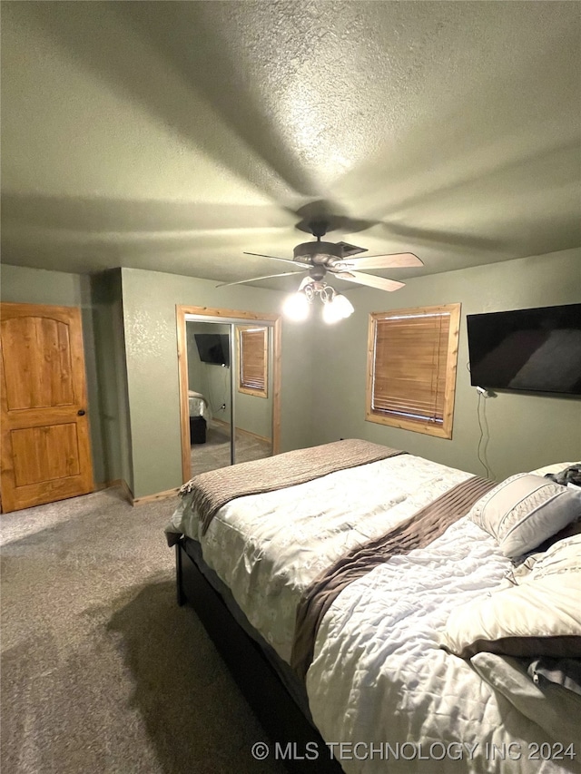 bedroom featuring a closet, ceiling fan, carpet flooring, and a textured ceiling