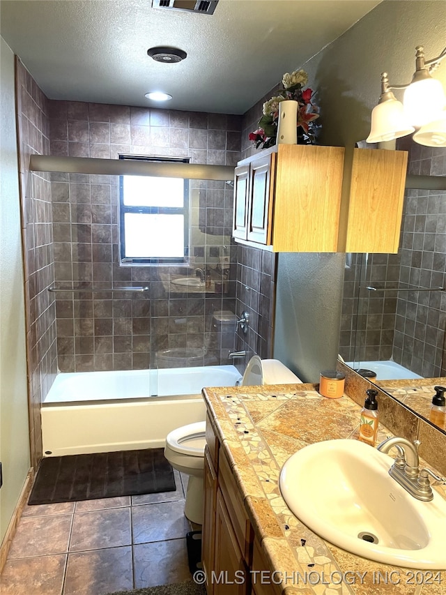 full bathroom with combined bath / shower with glass door, a textured ceiling, toilet, vanity, and tile patterned flooring