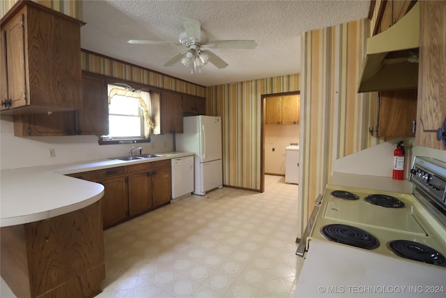 kitchen featuring white appliances, ceiling fan, washer / dryer, and sink