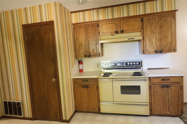 kitchen with electric range and a textured ceiling