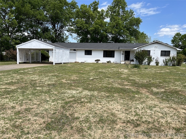 ranch-style home with a carport and a front lawn