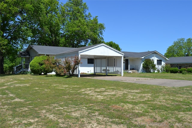 ranch-style home with a front lawn and a carport