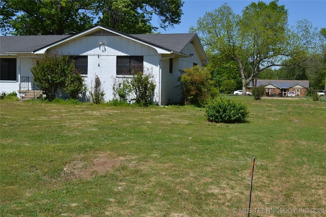 view of side of property with a yard