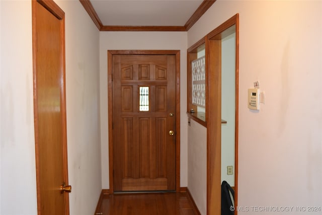 doorway with crown molding and hardwood / wood-style floors