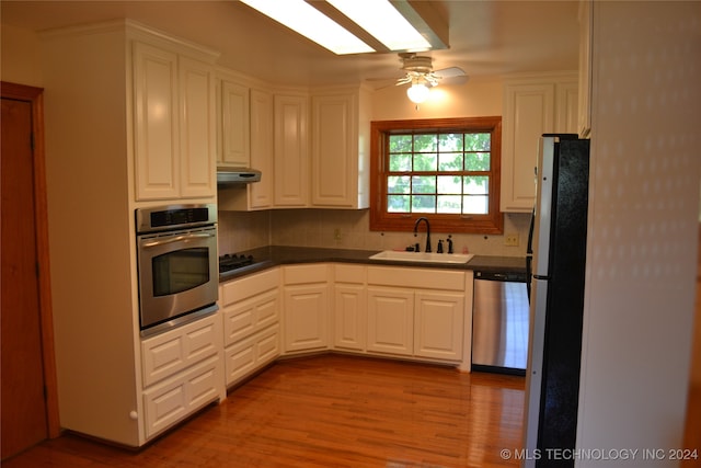 kitchen featuring sink, appliances with stainless steel finishes, and white cabinets