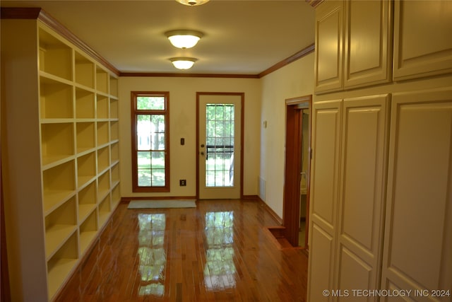 doorway featuring ornamental molding and hardwood / wood-style floors