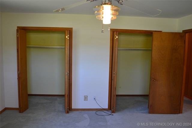 unfurnished bedroom featuring carpet floors, a closet, and ceiling fan