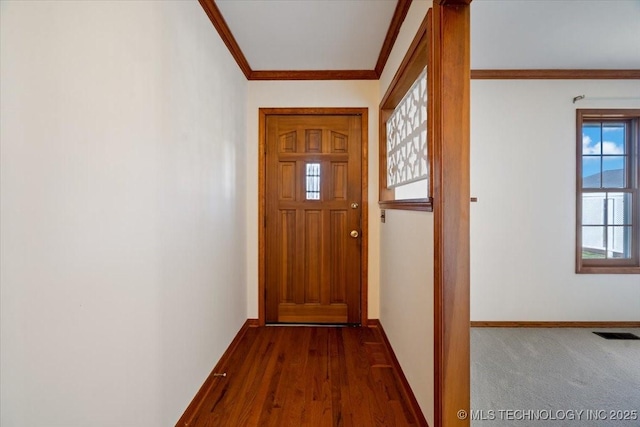 doorway featuring visible vents, baseboards, dark wood-style flooring, and crown molding