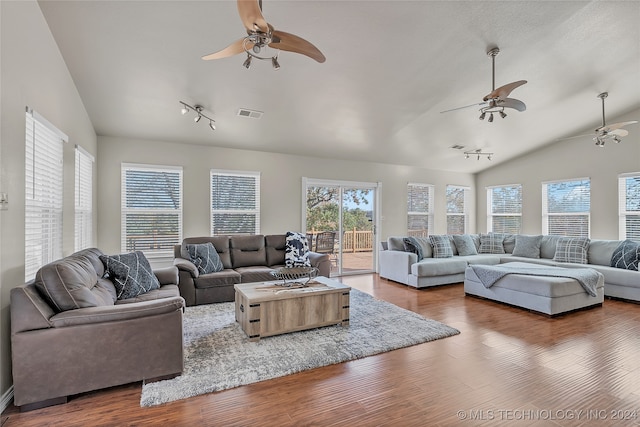 living room with hardwood / wood-style floors, vaulted ceiling, and ceiling fan