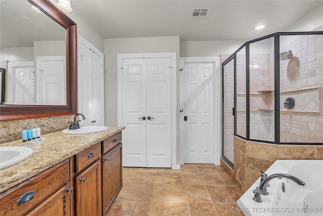 bathroom with vanity and independent shower and bath