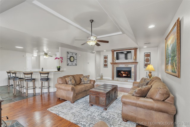 living room featuring ceiling fan and hardwood / wood-style floors