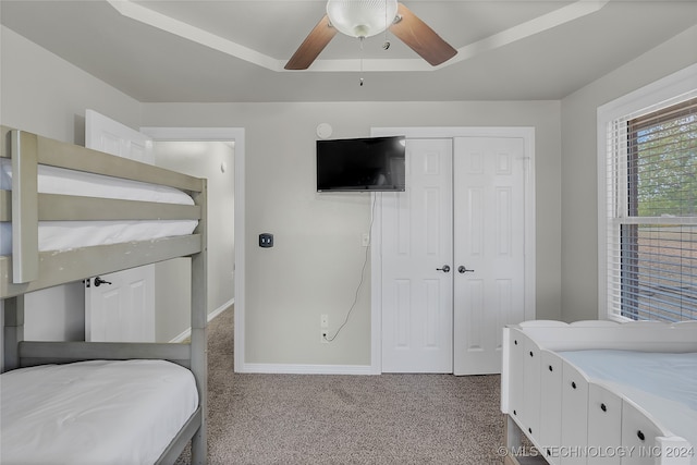 bedroom with light colored carpet, a closet, and ceiling fan