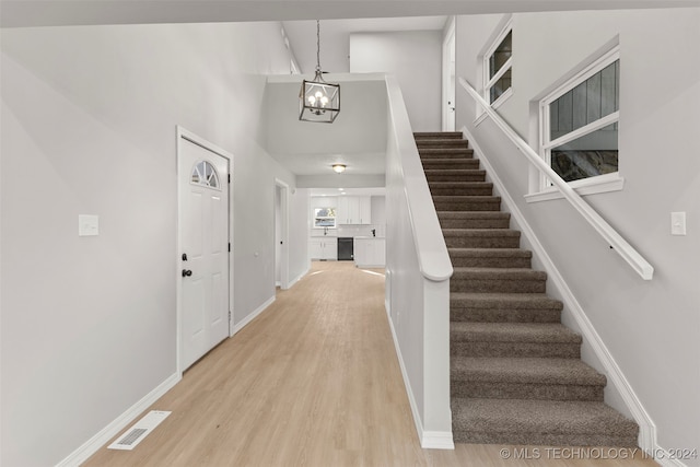 entrance foyer with an inviting chandelier and light wood-type flooring