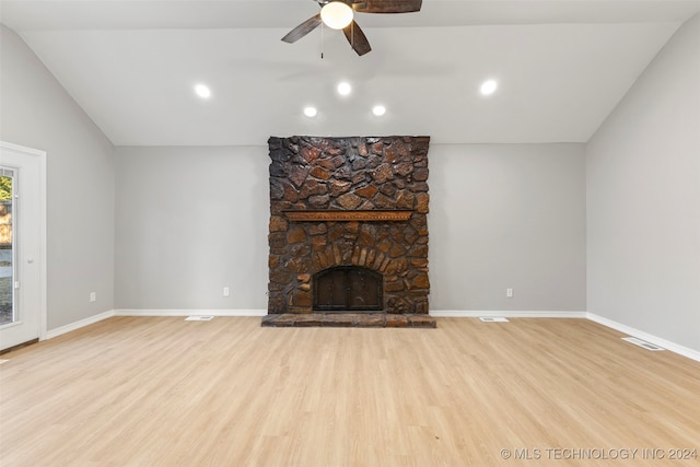 unfurnished living room with lofted ceiling, light hardwood / wood-style flooring, a fireplace, and ceiling fan