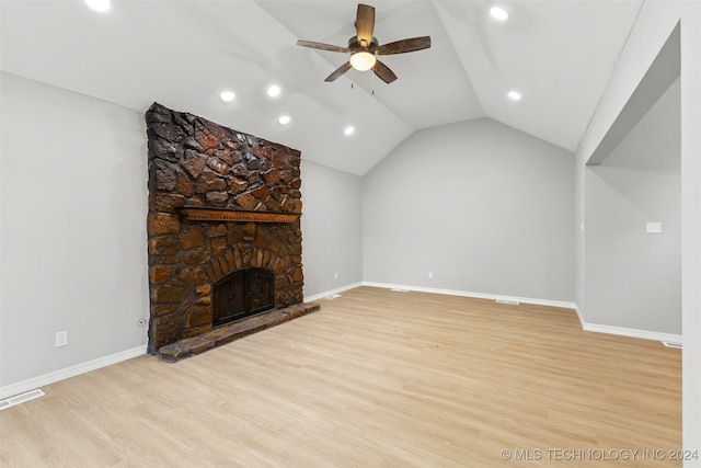 unfurnished living room with light hardwood / wood-style flooring, lofted ceiling, a fireplace, and ceiling fan