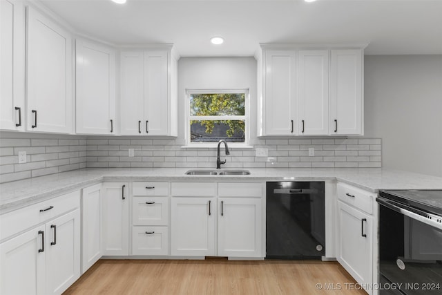 kitchen with white cabinetry, black appliances, sink, and light wood-type flooring