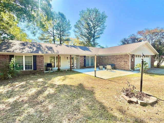 ranch-style home with a garage, a front yard, and a patio