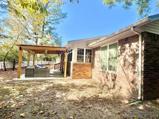 view of property exterior with a patio area and outdoor lounge area