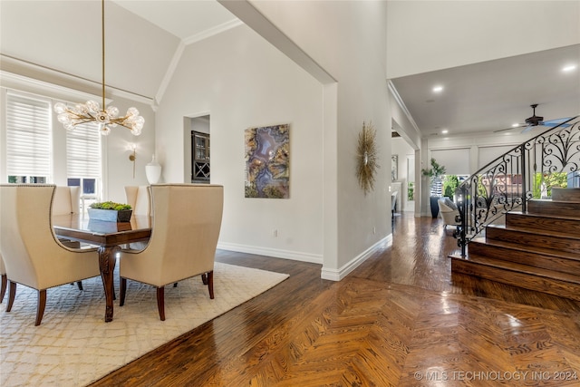 dining space with crown molding, high vaulted ceiling, wood-type flooring, and ceiling fan with notable chandelier