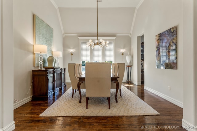 dining area featuring lofted ceiling, dark wood-type flooring, a notable chandelier, and ornamental molding