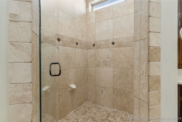 bathroom with a shower with shower door