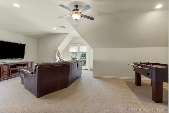 carpeted living room featuring ceiling fan and vaulted ceiling