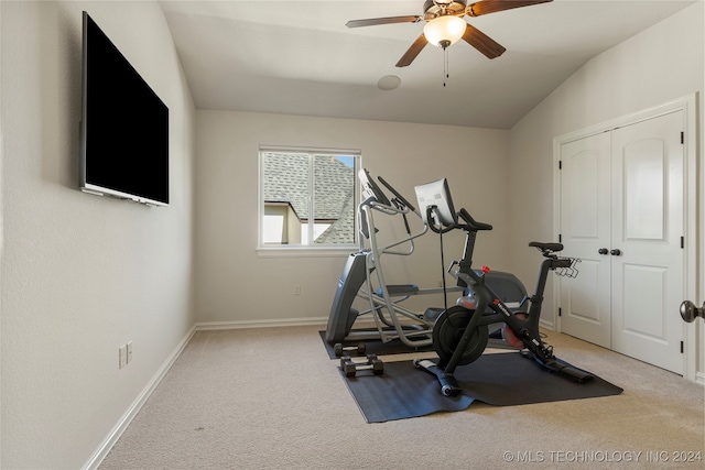 workout area featuring lofted ceiling, light colored carpet, and ceiling fan