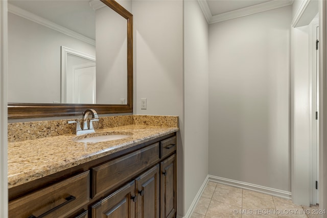 bathroom with vanity, ornamental molding, and tile patterned flooring