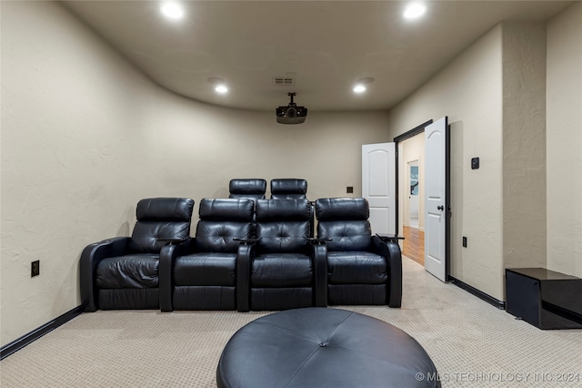 cinema room featuring light carpet