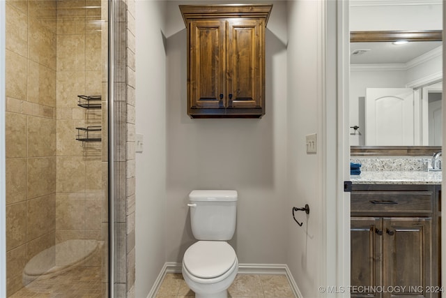 bathroom with toilet, tile patterned floors, walk in shower, vanity, and ornamental molding