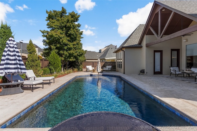 view of swimming pool with a patio area