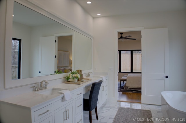 bathroom with a bathing tub, ceiling fan, and vanity