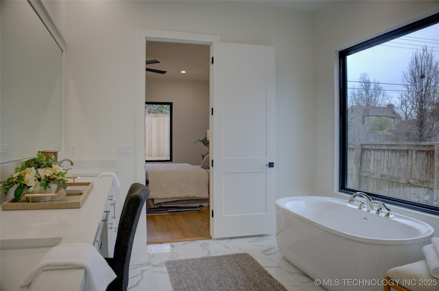 bathroom with a bath and ceiling fan