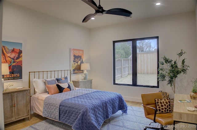 bedroom with ceiling fan and light hardwood / wood-style flooring