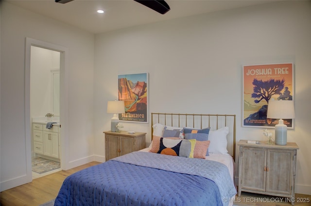 bedroom featuring light wood-type flooring, ensuite bath, and ceiling fan