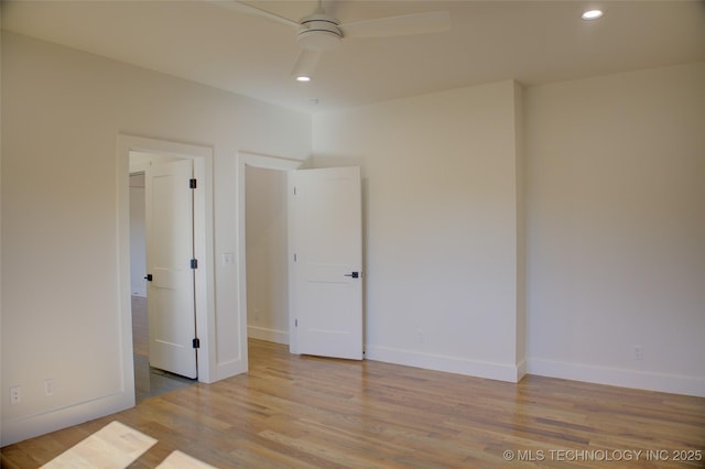 unfurnished bedroom featuring ceiling fan and light wood-type flooring