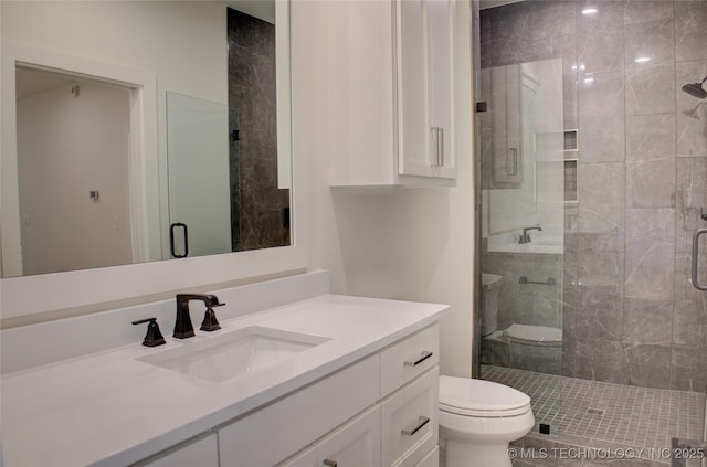 bathroom with vanity, toilet, and a shower with door