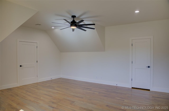 bonus room with light wood-type flooring, vaulted ceiling, and ceiling fan