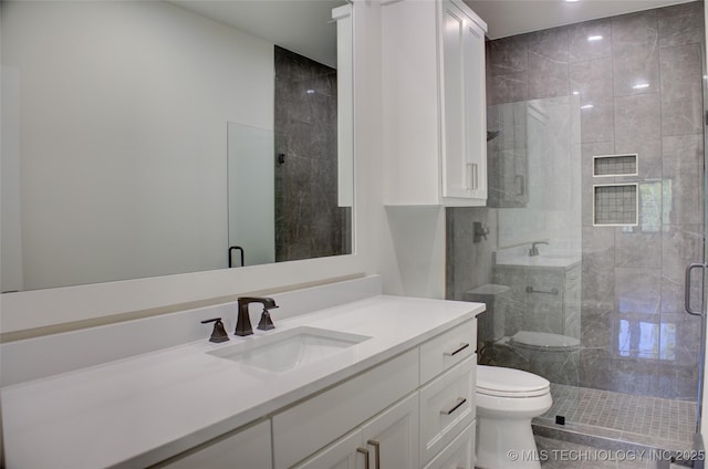 bathroom with vanity, toilet, and a shower with door