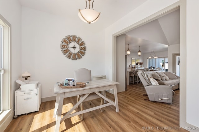 interior space with light hardwood / wood-style flooring and vaulted ceiling