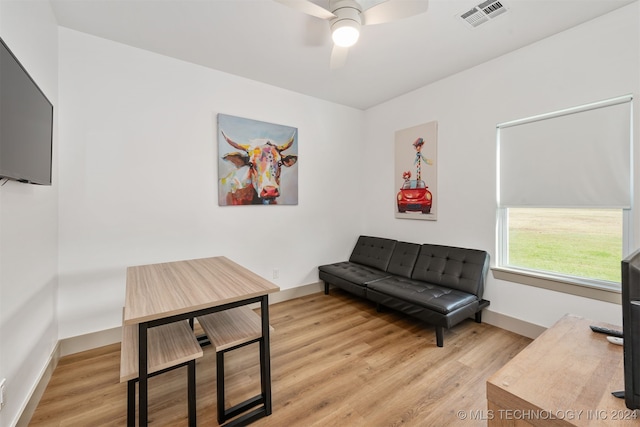 living area with light hardwood / wood-style floors and ceiling fan