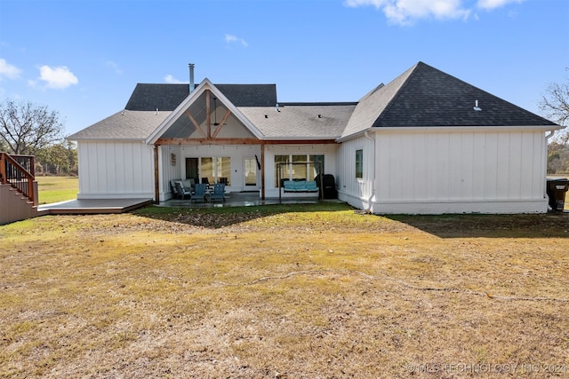 rear view of property with a patio and a yard