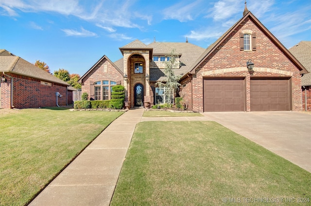 view of front facade with a front yard and a garage