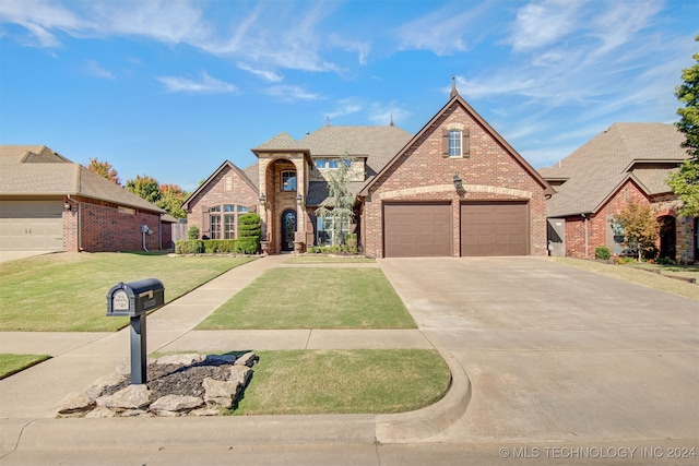 view of front of home featuring a front lawn and a garage