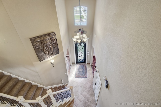 foyer entrance with a chandelier