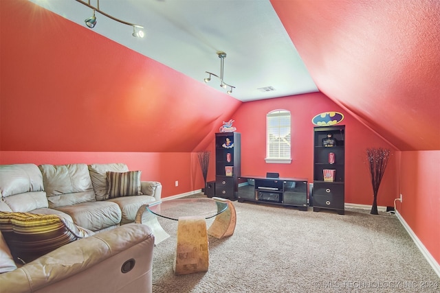 home theater room with lofted ceiling, carpet, and a textured ceiling