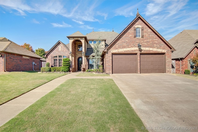 view of front of house with a garage and a front lawn