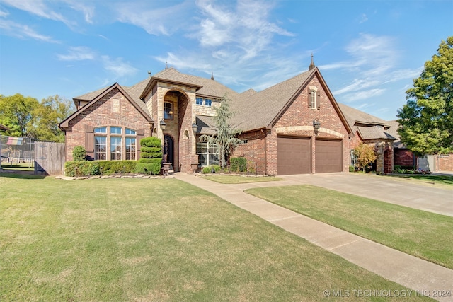 view of front of home with a front lawn and a garage