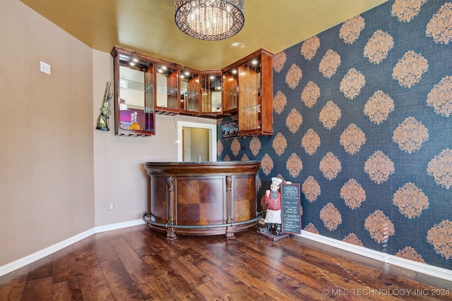 bar with dark hardwood / wood-style flooring