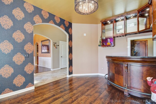 foyer entrance with a notable chandelier and wood-type flooring